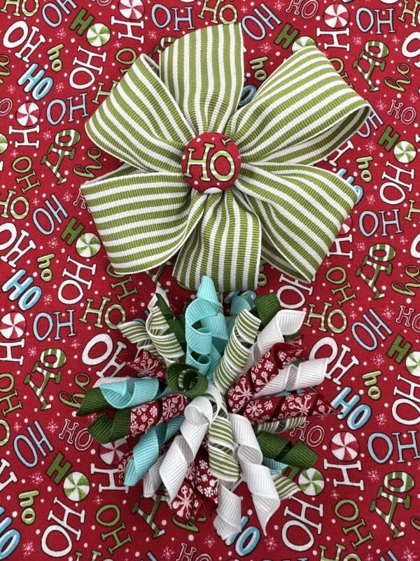 Two christmas bows on a red and green background.