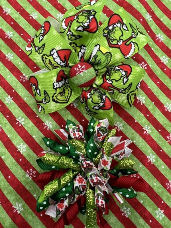 Two christmas bows on a red and green background.