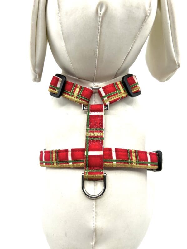 A mannequin mannequin wearing a red plaid dog harness.