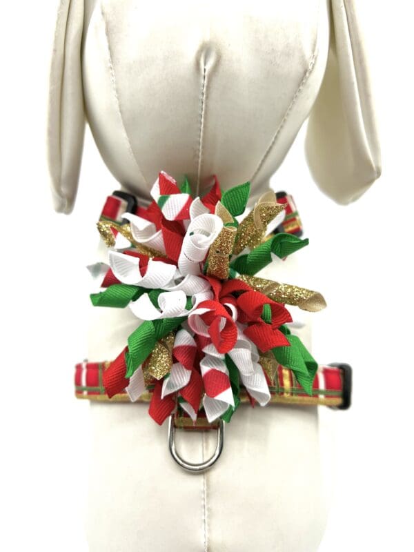 The back of a mannequin wearing a christmas ribbon collar.