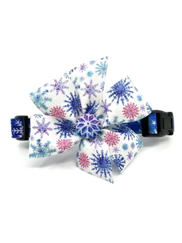 A dog collar with a blue and white snowflake design.