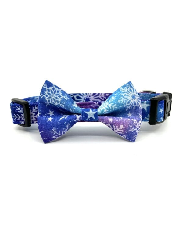 A blue and purple bow tie with snowflakes on it.