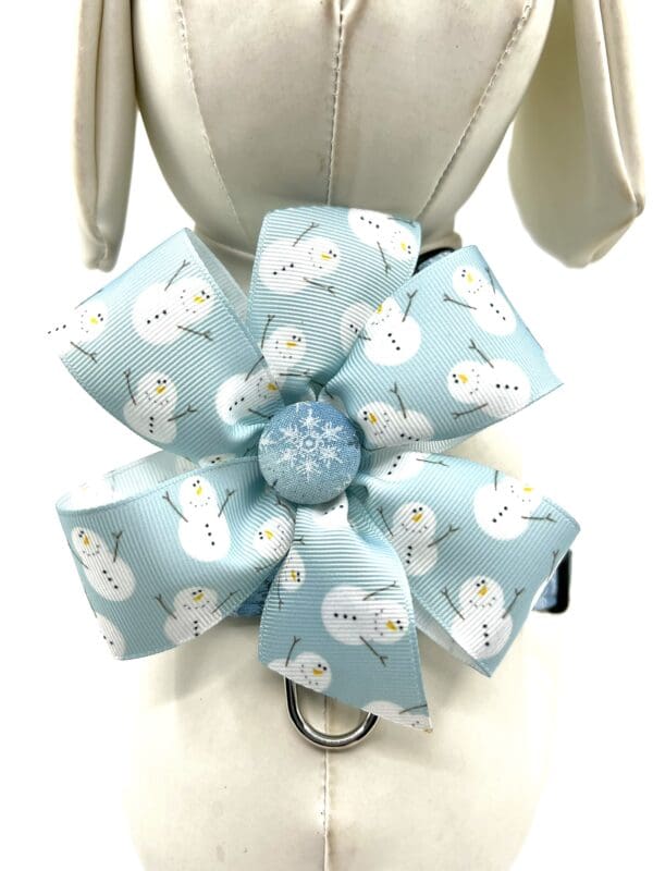 A blue dog collar with snowmen on it.