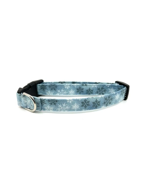 A blue dog collar with snowflakes on it.