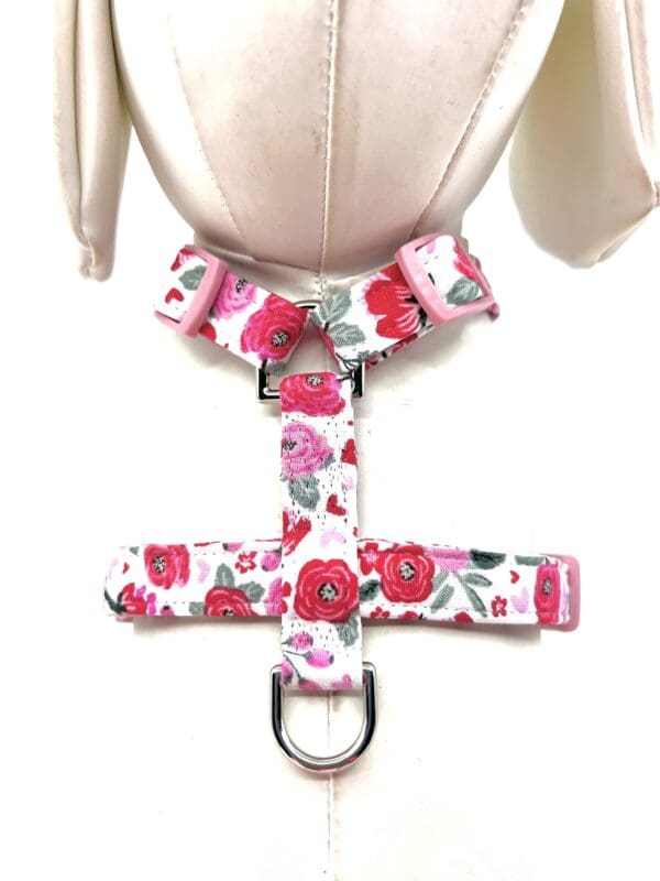 A mannequin with a pink and white floral dog harness.