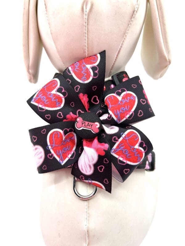 A mannequin wearing a dog collar with hearts on it.