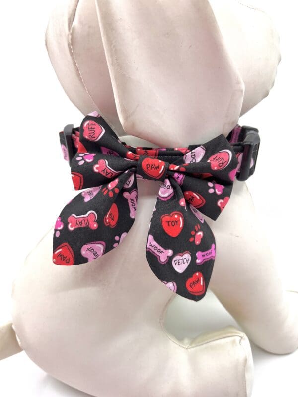 A dog wearing a bow tie with hearts on it.