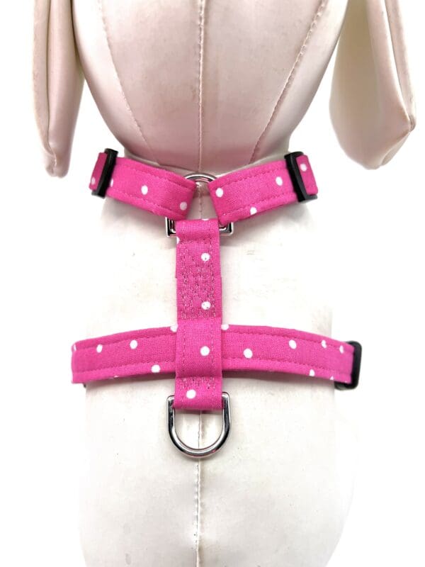 A pink harness on a mannequin.