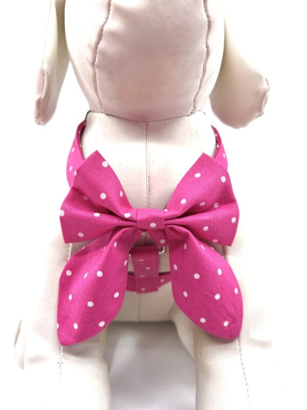 A stuffed dog wearing a pink bow.